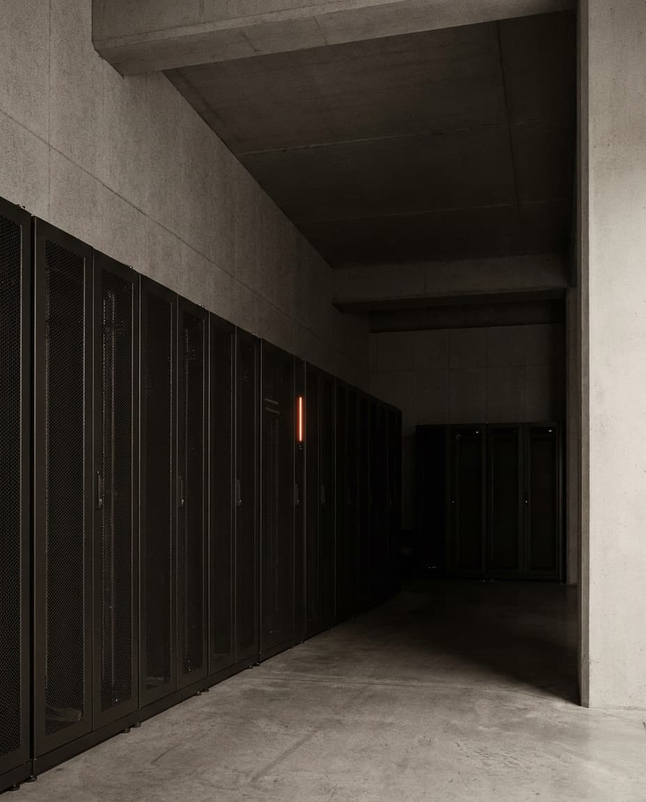A quiet data center aisle with a single orange status light